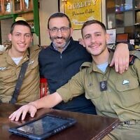 In this 2021 image, Rav Doron Perez (center) poses with his two soldier sons Yonatan (left, then 22) and Daniel (then 20), who was slain on October 7, 2023, and his remains captured by Hamas and taken to Gaza. (courtesy)