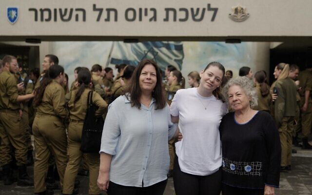 Former hostage Noga Weiss (center) with her mother Shiri (left), at the Tel Hashomer base in central Israel, May 6, 2024. (Israel Defense Forces)
