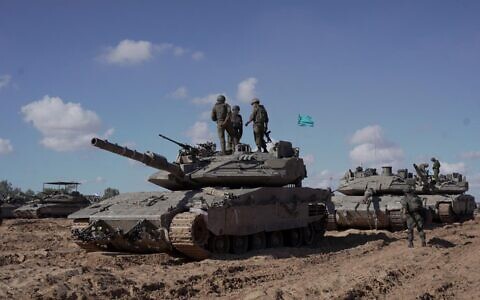 IDF soldiers under the Givati Brigade stand atop a tank in eastern Rafah in the southern Gaza Strip, in a handout picture released on May 10, 2024. (Israel Defense Forces)