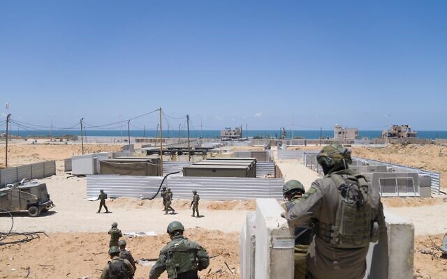 Israeli troops are seen on the coast of central Gaza, where a US-built floating pier is to be placed, in a handout photo issued May 16, 2024. (Israel Defense Forces)