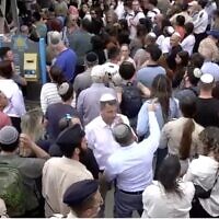 Hundreds of strangers attend the funeral of Holocaust survivor Esther Greizer in Haifa on May 6, 2024 (Screen grab via Channel 12 news)