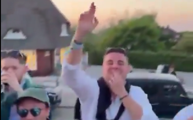 Screenshot of a man performing an apparent Nazi salute and Hitler mustache while chanting a Nazi slogan in Sylt, Germany, May 19, 2024. (X, used in accordance with Clause 27a of the Copyright Law)