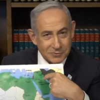 Prime Minister Benjamin Netanyahu holds up a map of the Middle East and North Africa during a TV interview, May 30, 2024. (YouTube, used in accordance with Clause 27a of the Copyright Law)