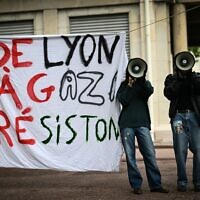 File: Demonstrators use megaphones next to a banner reading in French "From Lyon to Gaza, let's resist!" during aprotest action in the courtyard of the Institute of Political Studies (Sciences Po) building in Lyon, central Eastern France, on April 30, 2024. (Photo by OLIVIER CHASSIGNOLE / AFP)