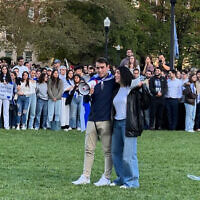 Columbia University students Eden Yadegar and Elisha H. Baker lead songs in support of Israel on October 12, 2023 at the Columbia University campus in New York. (courtesy)