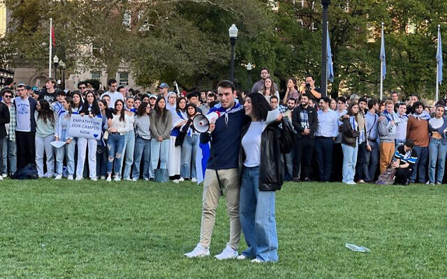 Columbia University students Eden Yadegar and Elisha H. Baker lead songs in support of Israel on October 12, 2023 at the Columbia University campus in New York. (courtesy)