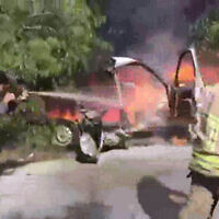 Lebanese firefighters work to extinguish a car that was hit by an alleged Israeli airstrike in the southern Lebanon village of Bafliyeh, May 9, 2024. (Screenshot: /X; used in accordance with Clause 27a of the Copyright Law)