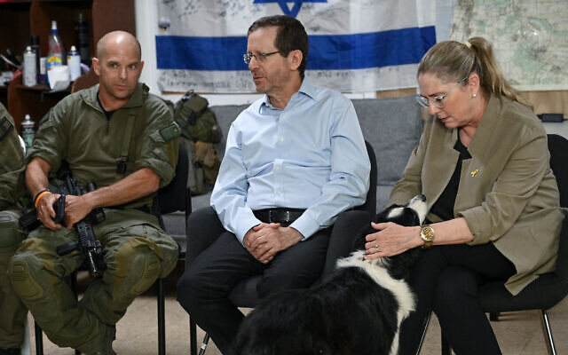 President Isaac Herzog, center, and his wife Michal, right, meet members of the security squad of Kibbutz Hanita in the north, June 25, 2024. (Maayan Toaf/GPO)