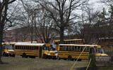 School buses drive from the campus of East Brunswick High School after the school day on February 22, 2018, in East Brunswick, New Jersey. (DOMINICK REUTER / AFP)