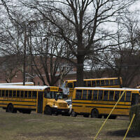School buses drive from the campus of East Brunswick High School after the school day on February 22, 2018, in East Brunswick, New Jersey. (DOMINICK REUTER / AFP)