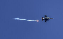 Illustrative: A picture taken from Kiryat Shmona in northern Israel shows an Israeli fighter jet firing a flare over southern Lebanon on May 16, 2024. (Menahem Kahana/AFP)