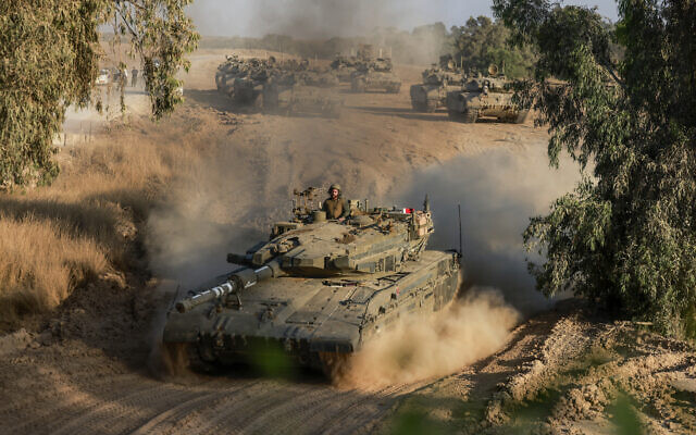 An Israeli tank drives in an area of Israel's southern border with the Gaza Strip on June 4, 2024. (Menahem Kahana/AFP)
