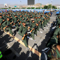 Yemeni youths take part in a parade in support of the Iran-backed Houthi rebels on June 9, 2024. (Mohammed Huwais/AFP)
