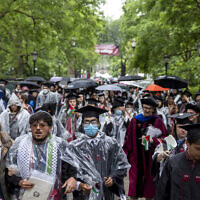 University of Chicago students, including Youssef Hasweh, second from left, one of four students the university is withholding degrees from due to their involvement in an anti-Israel encampment, walk out of the university's convocation ceremony, June 1, 2024. (Vincent Alban/Chicago Tribune via AP)