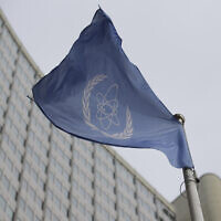 The flag of the International Atomic Energy Agency flies in front of its headquarters during an IAEA Board of Governors meeting in Vienna, Austria, on February 6, 2023. (Heinz-Peter Bader/AP)