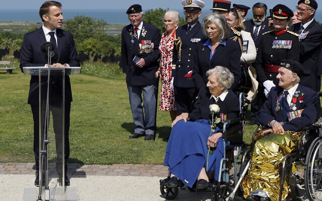 French President Emmanuel Macron addresses British D-Day veterans during a commemorative ceremony marking the 80th anniversary of the World War II Allied landings in Normandy, at the World War II British Normandy Memorial of Ver-sur-Mer, Thursday, June 6, 2024. (Ludovic Marin/Pool via AP)