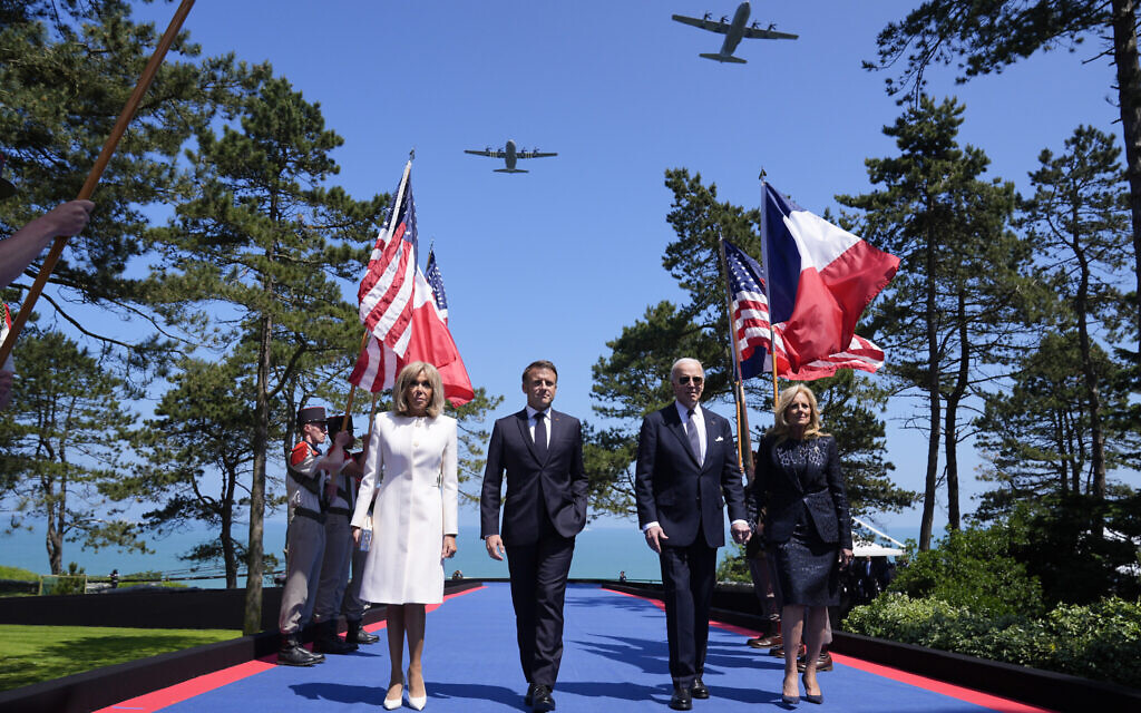 US President Joe Biden, first lady Jill Biden, French President Emmanuel Macron, his wife Brigitte Macron, walk on stage during ceremonies to mark the 80th anniversary of D-Day, June 6, 2024, in Normandy. (AP Photo/Evan Vucci)