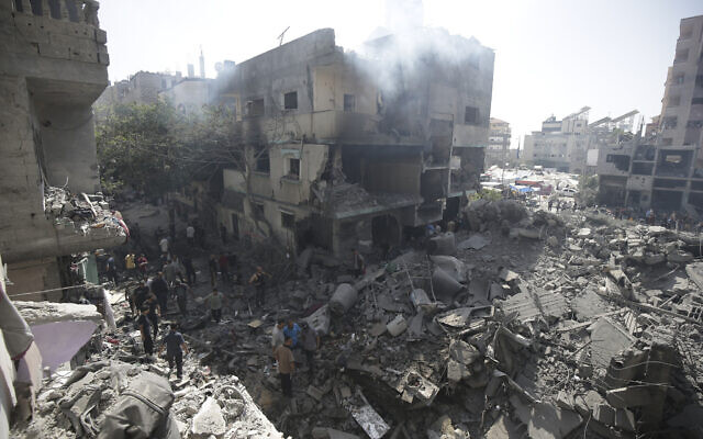 Palestinians look at the aftermath of strikes during a hostage rescue mission by Israeli forces in Nuseirat refugee camp, Gaza Strip, June 8, 2024 (AP Photo/Jehad Alshrafi)