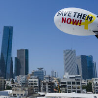 Family and friends of the remaining hostages held in the Gaza Strip launch a blimp calling for their release in Tel Aviv, June 9, 2024. (AP Photo/Ariel Schalit)