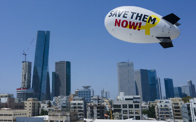 Family and friends of the remaining hostages held in the Gaza Strip launch a blimp calling for their release in Tel Aviv, June 9, 2024. (AP Photo/Ariel Schalit)