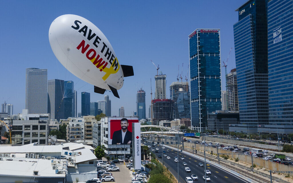 A small airship calling for their release of hostages held in Gaza flies over Tel Aviv on June 9, 2024. (AP/Ariel Schalit)