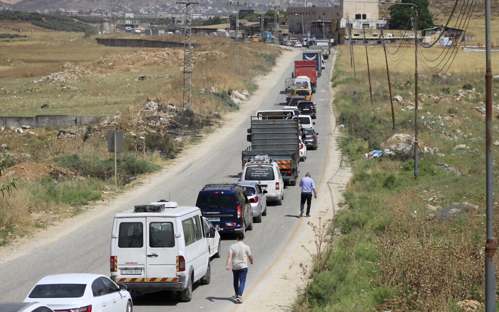 Palestinians wait at a checkpoint south of the West Bank city of Nablus, after the Israeli army closed it during  Jerusalem Day celebrations on June 5, 2024. (Nasser Ishtayeh/Flash90)