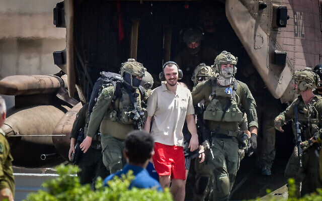 Rescued hostage Andrey Kozlov, freed by the IDF from Hamas captivity in Gaza, is escorted from an IDF helicopter on arrival at the Sheba Medical Center in Ramat Gan, June 8, 2024. (Avshalom Sassoni/Flash90)