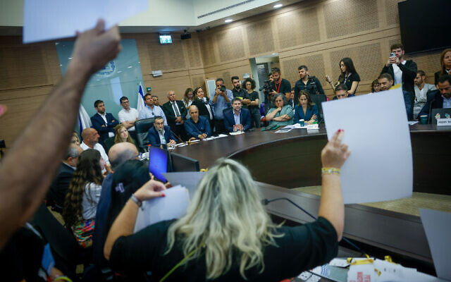 Relatives of Israelis held hostage in the Gaza Strip react to Finance Minister Bezalel Smotrich during a Finance Committee meeting at the Knesset on June 10, 2024 (Chaim Goldberg/Flash90)