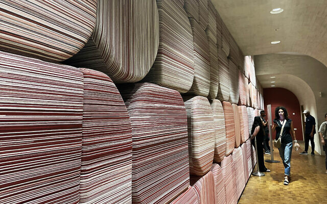 Textile artist Yael Cnaani channeled piles of books and the exterior walls of the building in creating her artwork for the National Library of Israel, inaugurated June 4, 2024 (Jessica Steinberg/Times of Israel)