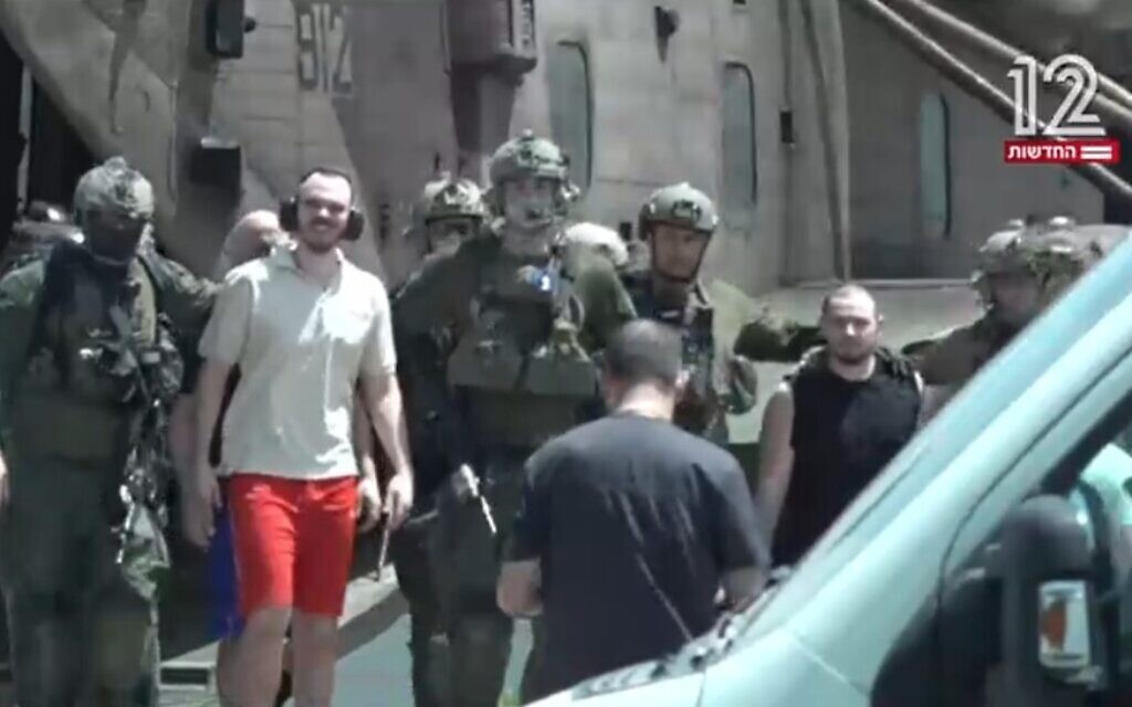 Rescued hostages Andrey Kozlov (in red shorts) and Almog Meir (in black sleeveless shirt) seen on their return to Israel, June 8, 2024 (Channel 12 screenshot; used in accordance with clause 27a of the Copyright law)