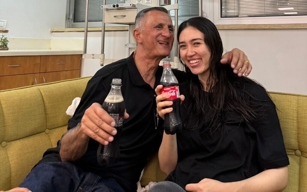 Rescued hostage Noa Argamani is seen reunited with her father, June 8, 2024 (Courtesy)