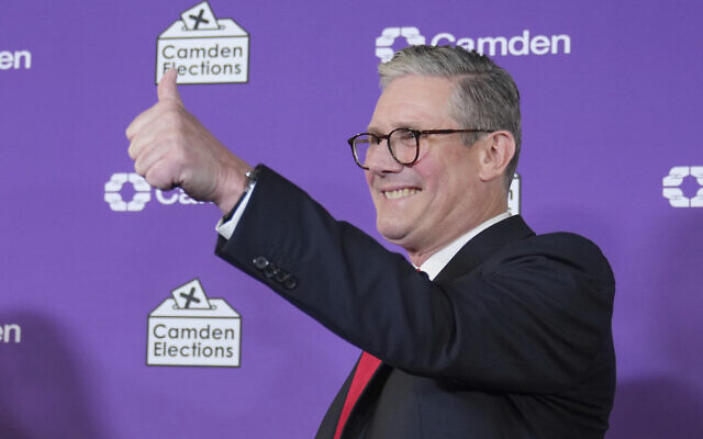 Britain's Labour Party leader and incoming prime minister Keir Starmer gives a thumbs up to his supporters after he was elected for the Holborn and St Pancras constituency, in London, Friday, July 5, 2024.(AP/Kin Cheung)