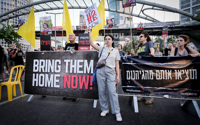 Activist hold a protest calling for the release of hostages held in Gaza, outside the Defense Ministry headquarters in Tel Aviv, July 4, 2024. (Avshalom Sassoni/Flash90)