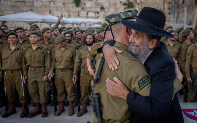 Israeli soldiers from the ultra-Orthodox Netzah Yehuda Battalion attend a swearing-in ceremony at the Western Wall in Jerusalem's Old City, July 10, 2024. (Chaim Goldberg/Flash90)