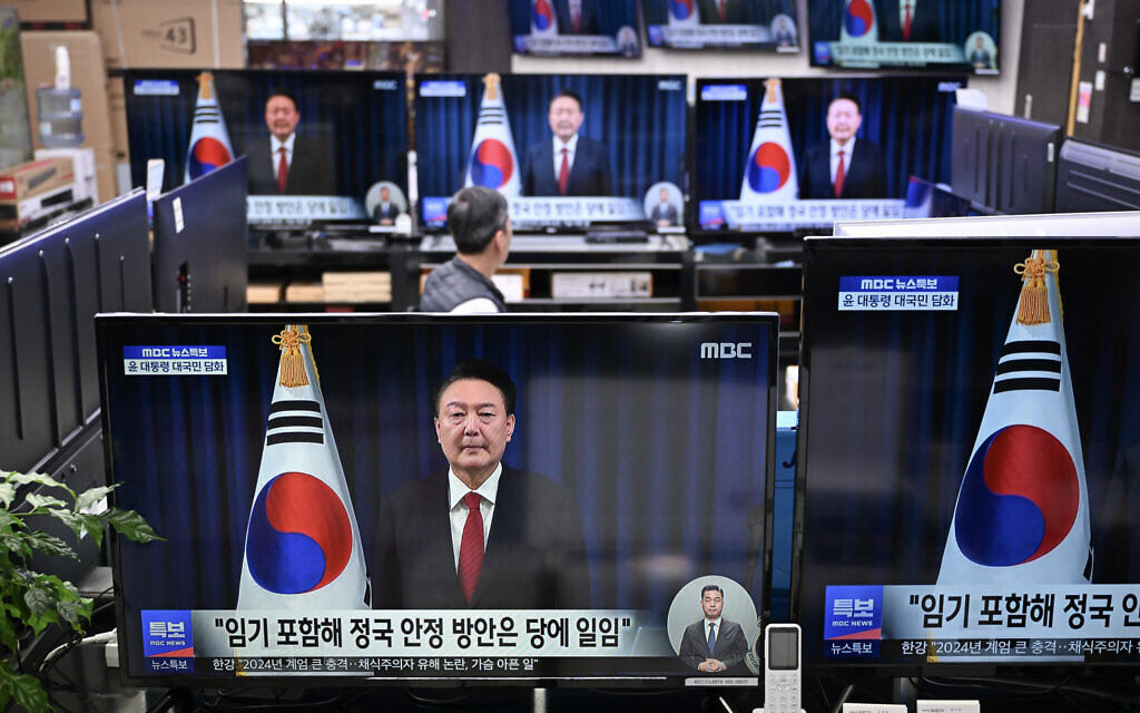 Television screens show live footage of an address by South Korea's President Yoon Suk Yeol, at an electronic market in Seoul on December 7, 2024. (JUNG Yeon-je / AFP)